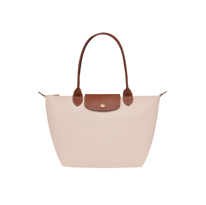 Beige handbag with brown leather handle and flap on a light gray background- beige purse