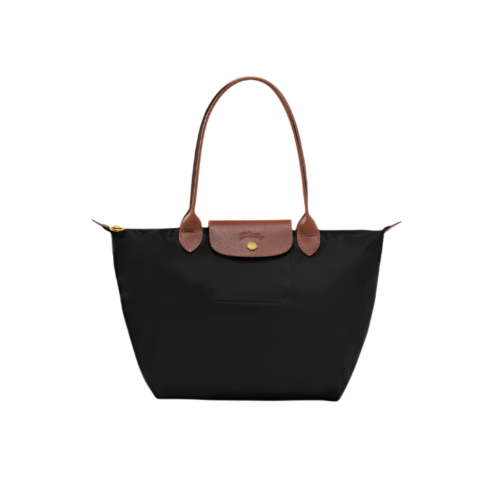 Black tote bag with brown leather handle and trim on a white background- black purse