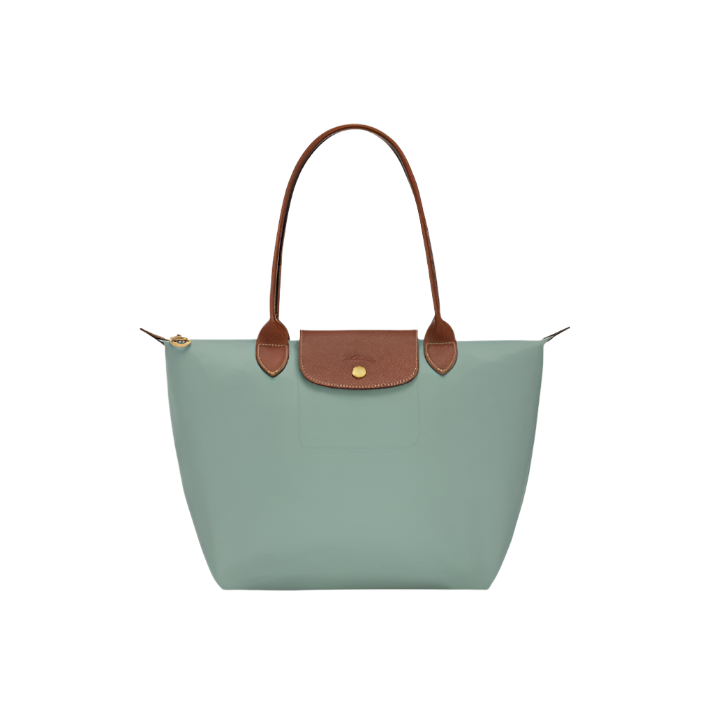 Green handbag with brown leather accents on a light gray background- green purse