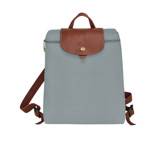 Grey longchamp backpack with brown leather accents on a white background
