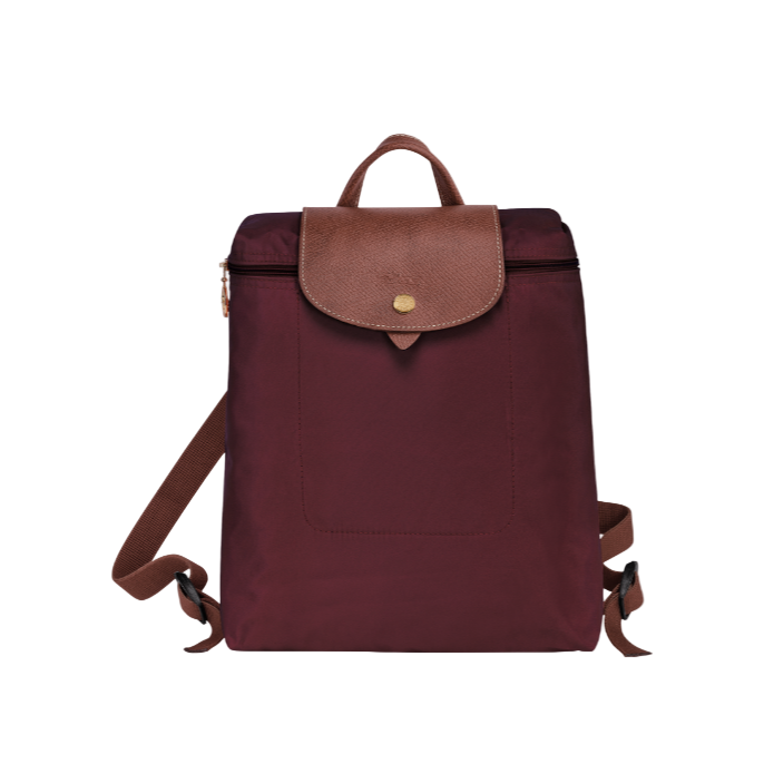 Maroon longchamp backpack with brown leather accents on a white background