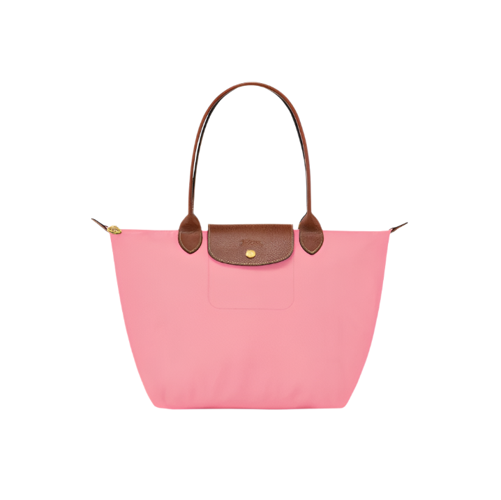 Pink handbag with brown handles and trim on a light gray background- pink purse