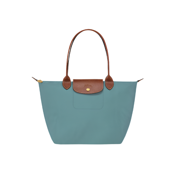 Teal handbag with brown leather handle and accents on a light gray background- teal purse