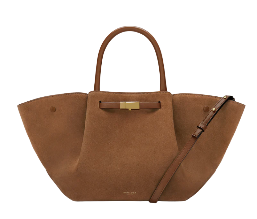 tan suede midi luxury handbag with a gold clasp on a white background