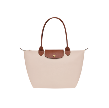 Beige handbag with brown leather handle and flap on a light gray background- beige purse