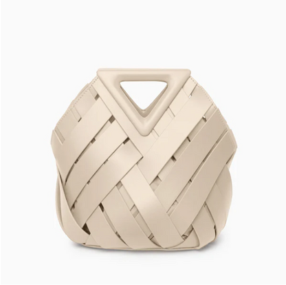 Beige veya handbag with a geometric handle on a white background