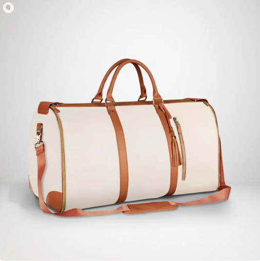 Beige duffel bag with brown leather straps on a white background