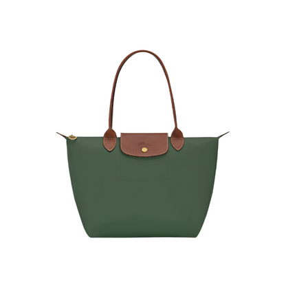 Green handbag with brown handles and trim on a light gray background- green purse
