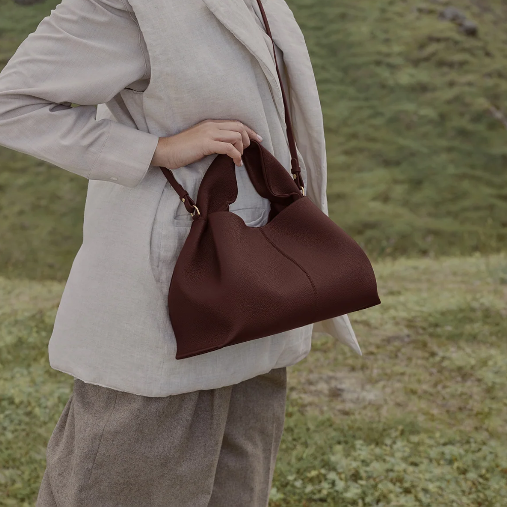 La Vincenza Handbag- burgundy purse model holding