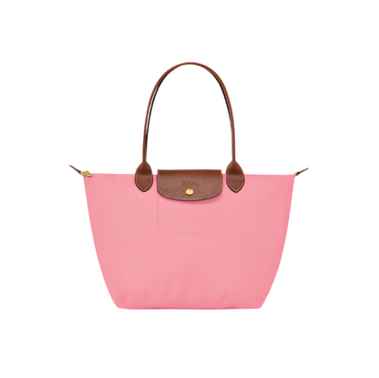 Pink handbag with brown handles and trim on a light gray background- pink purse