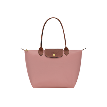 Pink tea handbag with brown handles and trim on a light gray background- pink tea purse