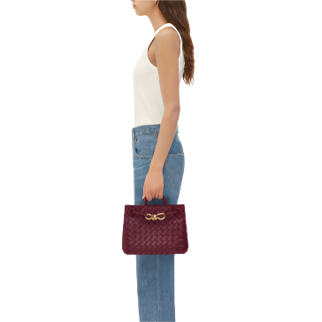 andiamo handbag- small burgundy purse model holding