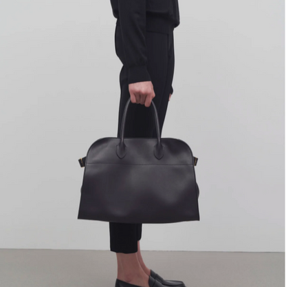 medium margaux handbag- black leather purse model holding