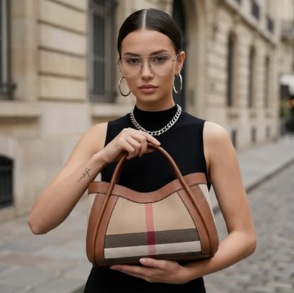 Woman holding brown luno handbag on a city street